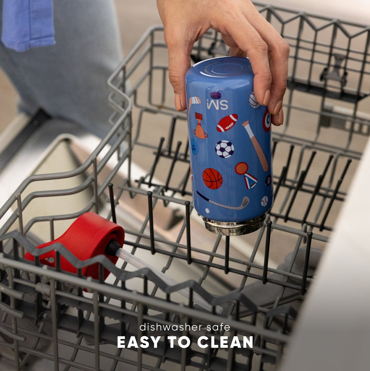 Blue Simple Modern kids water bottle with colorful sports ball print being held in an open dishwasher. Text reads "dishwasher safe" and "EASY TO CLEAN." Demonstrates product durability and easy maintenance.